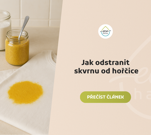 Fotografie na světlé béžové, jemně tečkované kuchyňské desce zachycuje velkou žlutou skvrnu od hořčice na složeném bílém tričku v popředí.