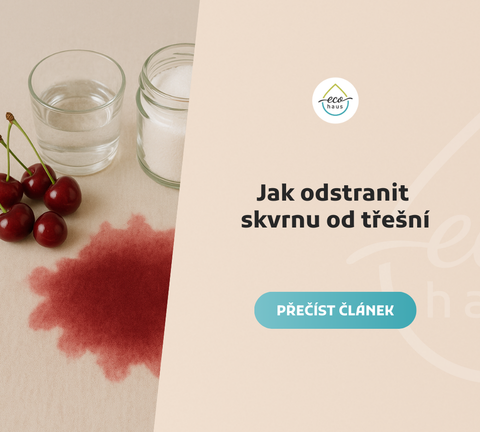 Pohled shora na béžovou látku s velkou tmavou skvrnou od třešní v popředí.