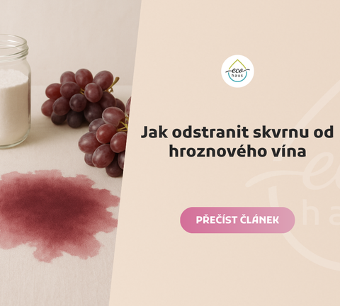 Skvrna od hroznového vína na světlém lněném ubrusu, v popředí tmavě červená skvrna, v pozadí dvě hroznové hrozny a sklenice se sypkým bílým práškem.